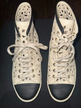 CHANEL Cream Cutout High-Top Sneakers with Black Toe Caps